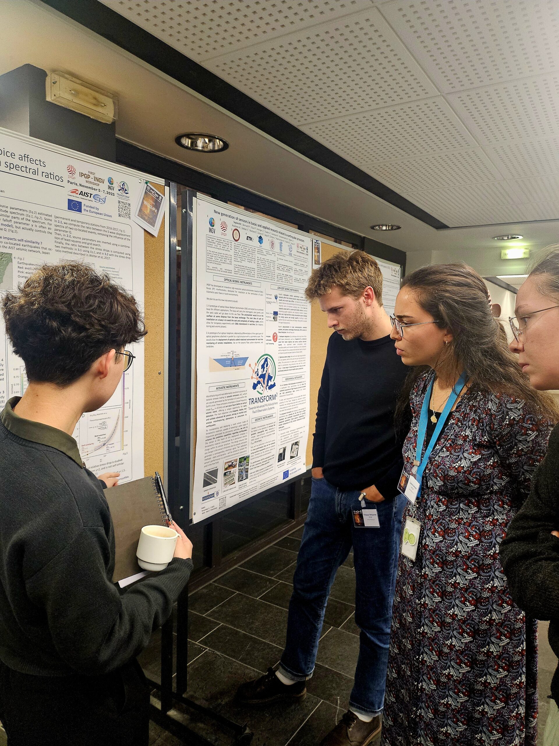 Photo of participants discussing with Naossa Maille-Okada during the poster session.